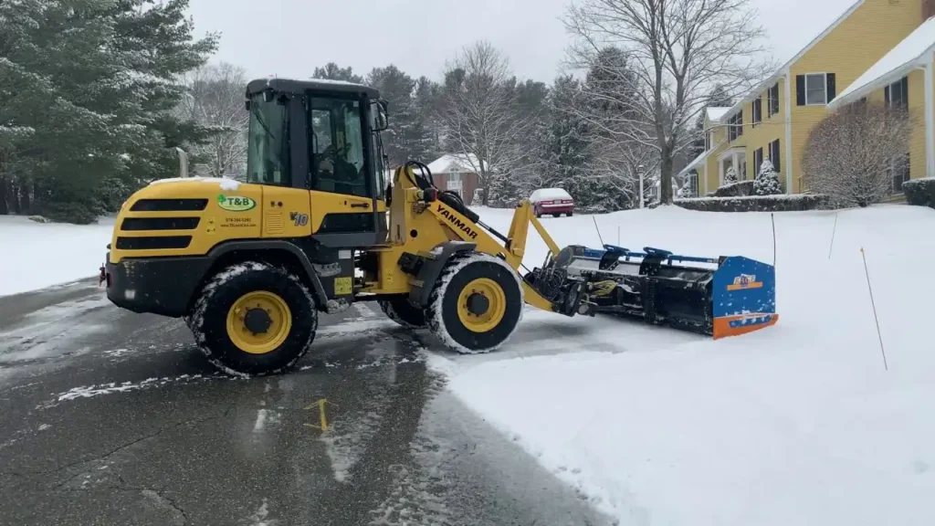 Trained operator plowing a Green Bay driveway without damaging the surface