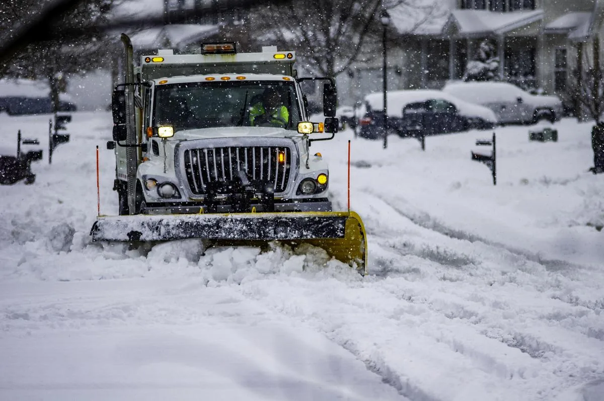 Snow plowing Bellevue, WI clearing a driveway early morning